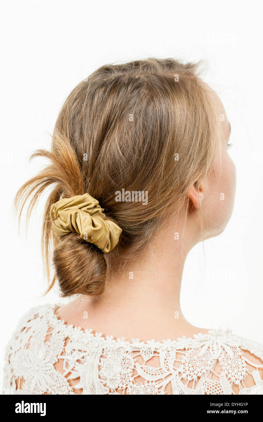 Studio shot of young woman with casual messy chignon hairstyle Stock Photo