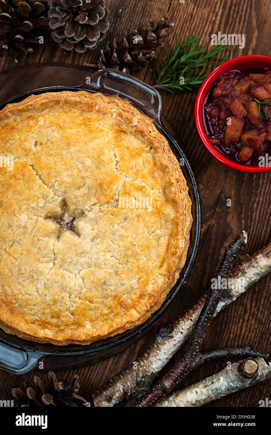Traditional pork meat pie Tourtiere with apple and cranberry chutney from Quebec, Canada, top view Stock Photo