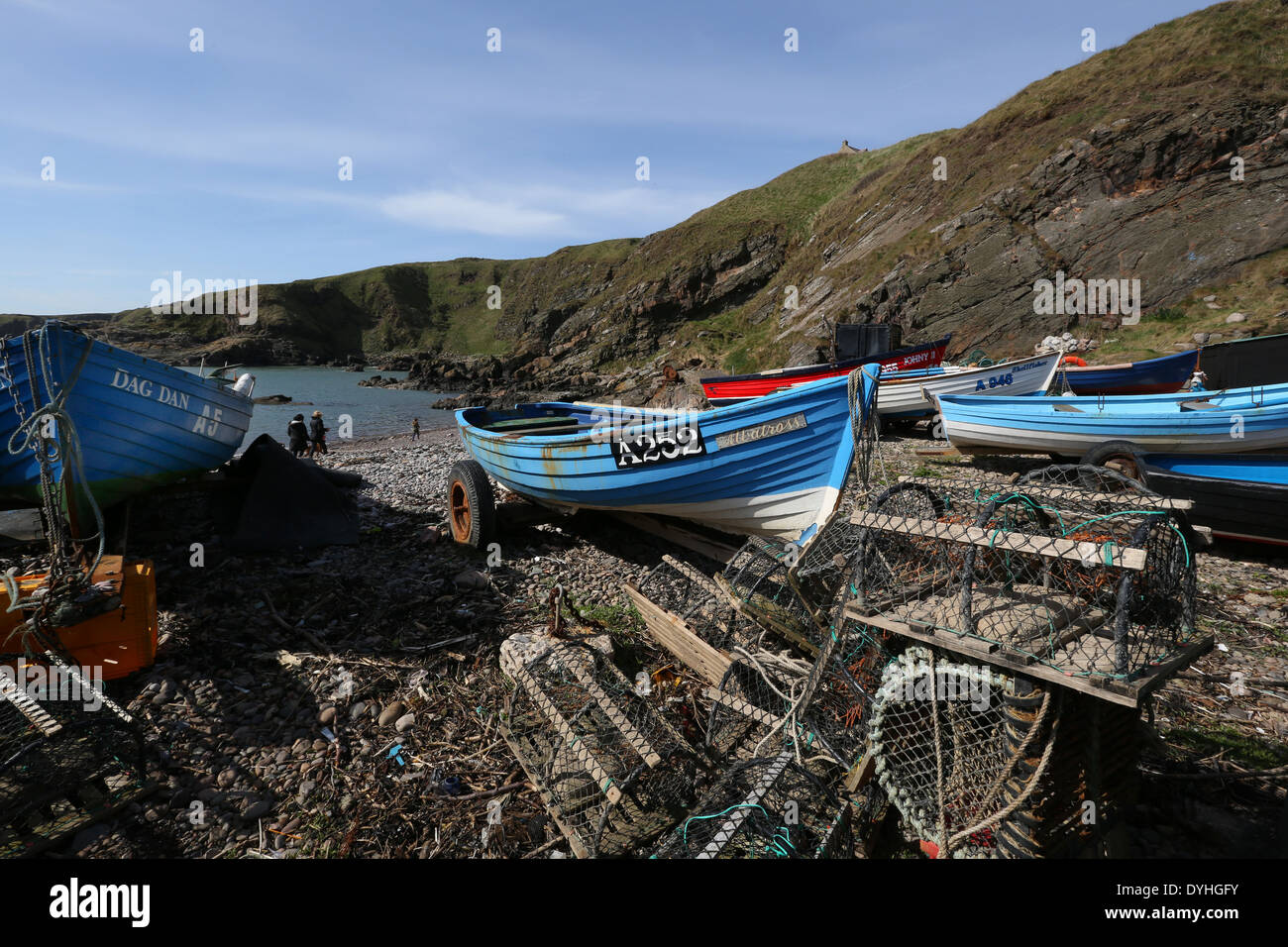 Small fishing boats at the picturesque harbour at Cove Bay, Aberdeen city, Scotland, UK Stock Photo
