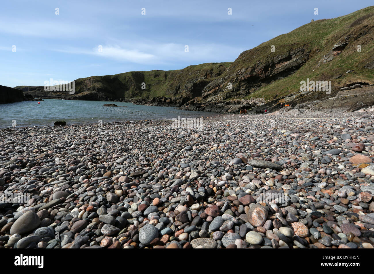 Pebbles and stones at the picturesque harbour at Cove Bay, Aberdeen city, Scotland, UK Stock Photo