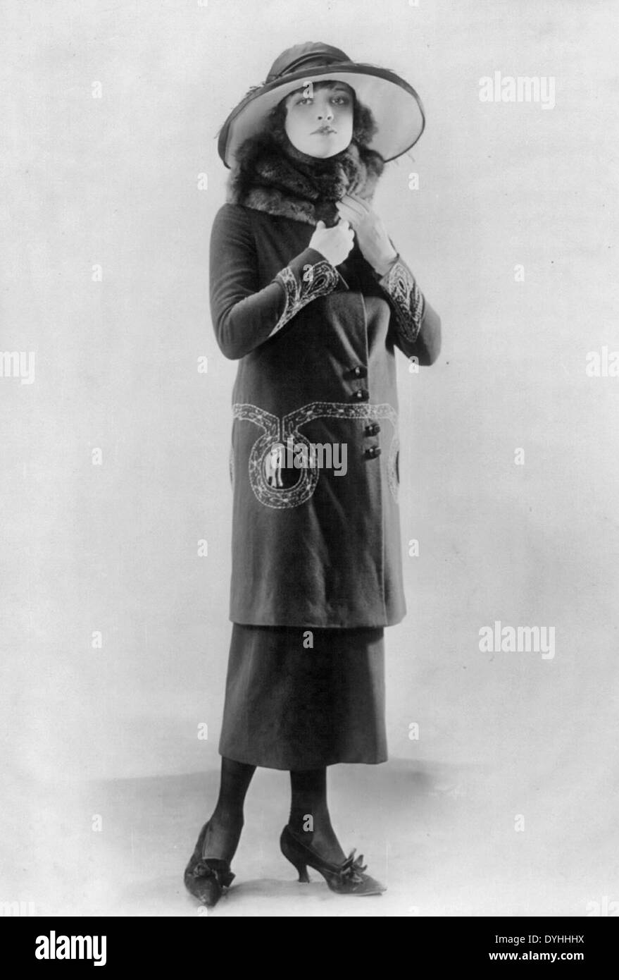 Woman modeling hat and suit with long coat and fur collar, circa 1920 Stock Photo