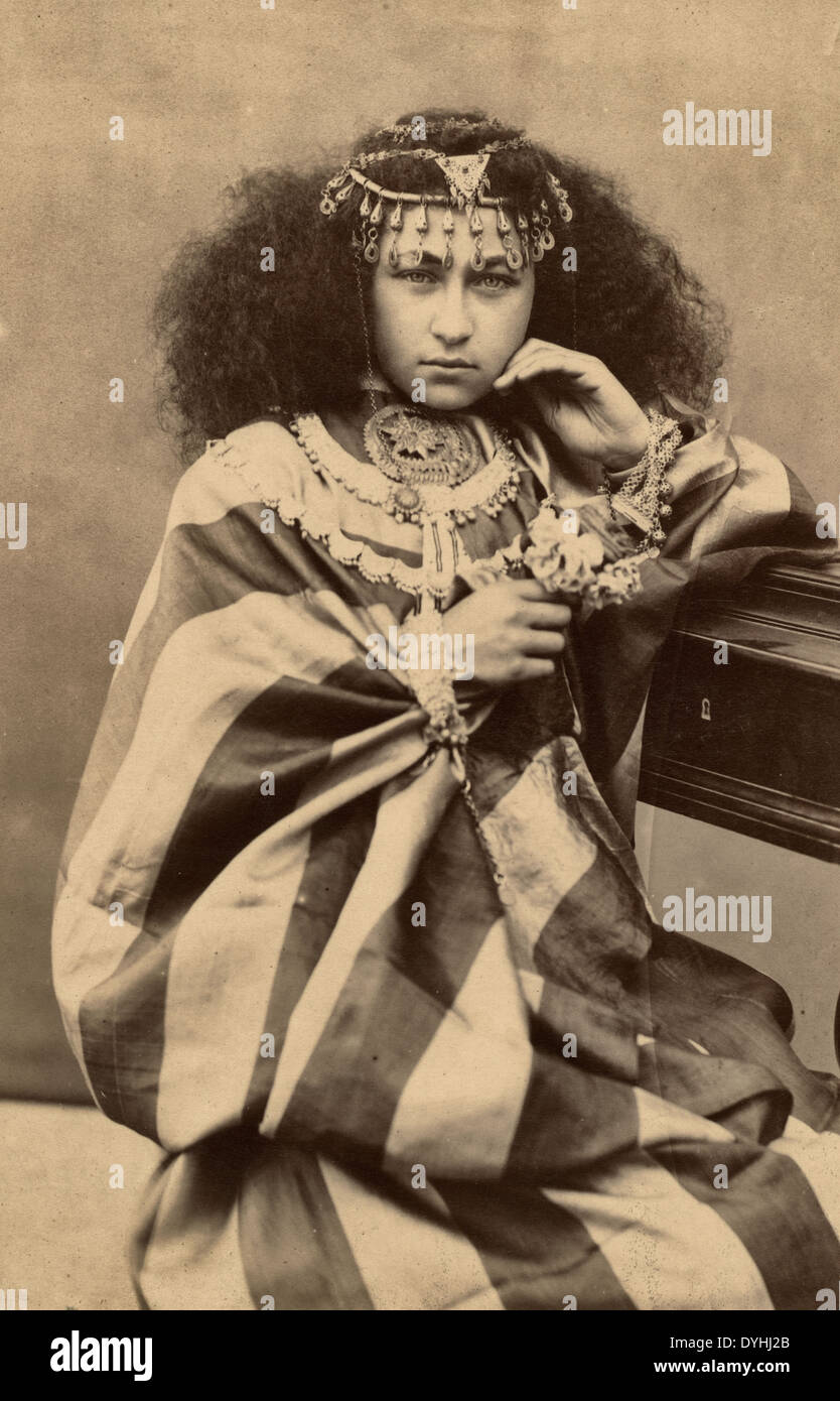 Woman, three-quarter length portrait, seated, facing front, wearing elaborate jewelry, circa 1880 Stock Photo