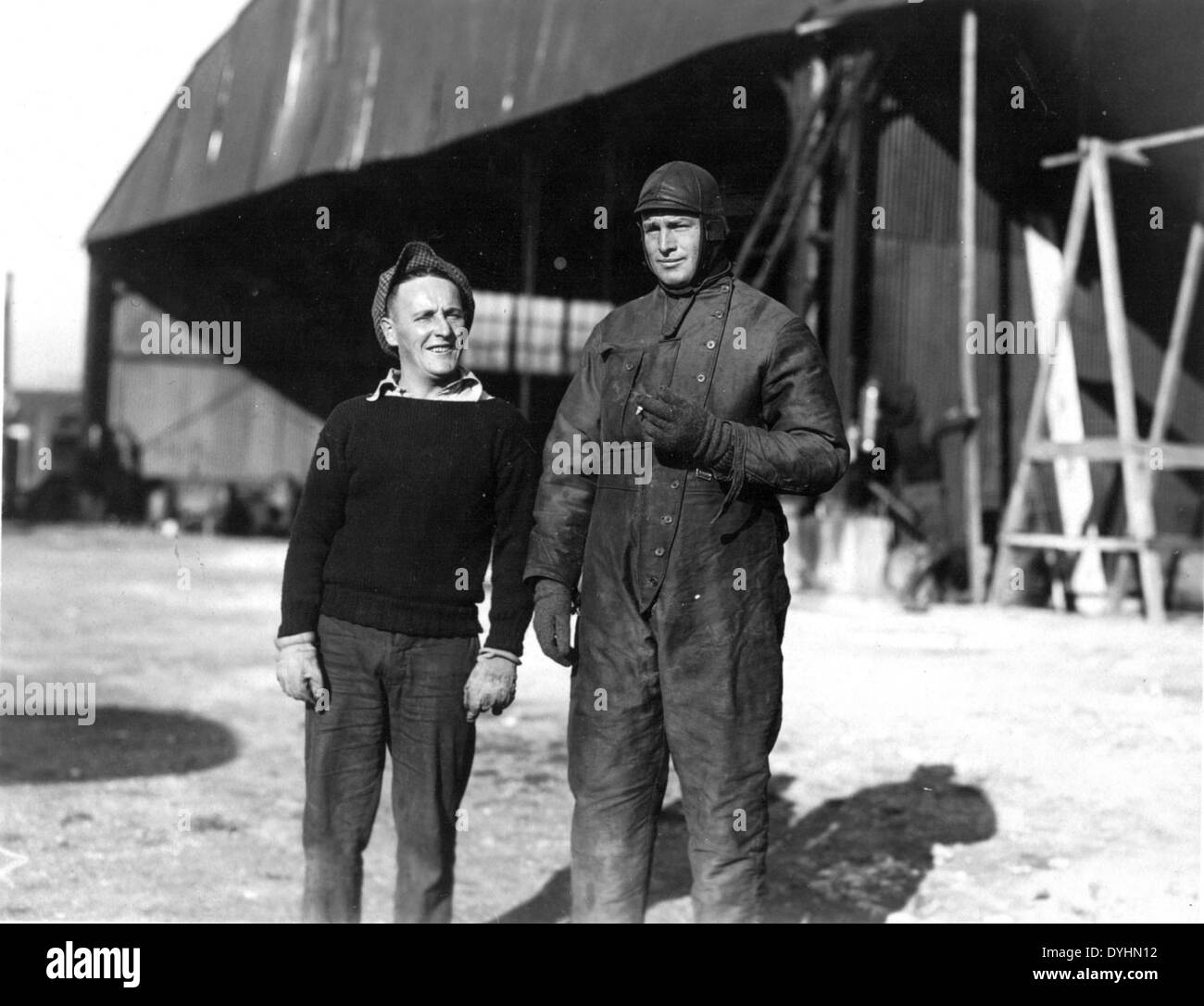 E.G. Leonhardt Special Collection Photo 2 men, one in flight suit in front of a hangar Stock Photo