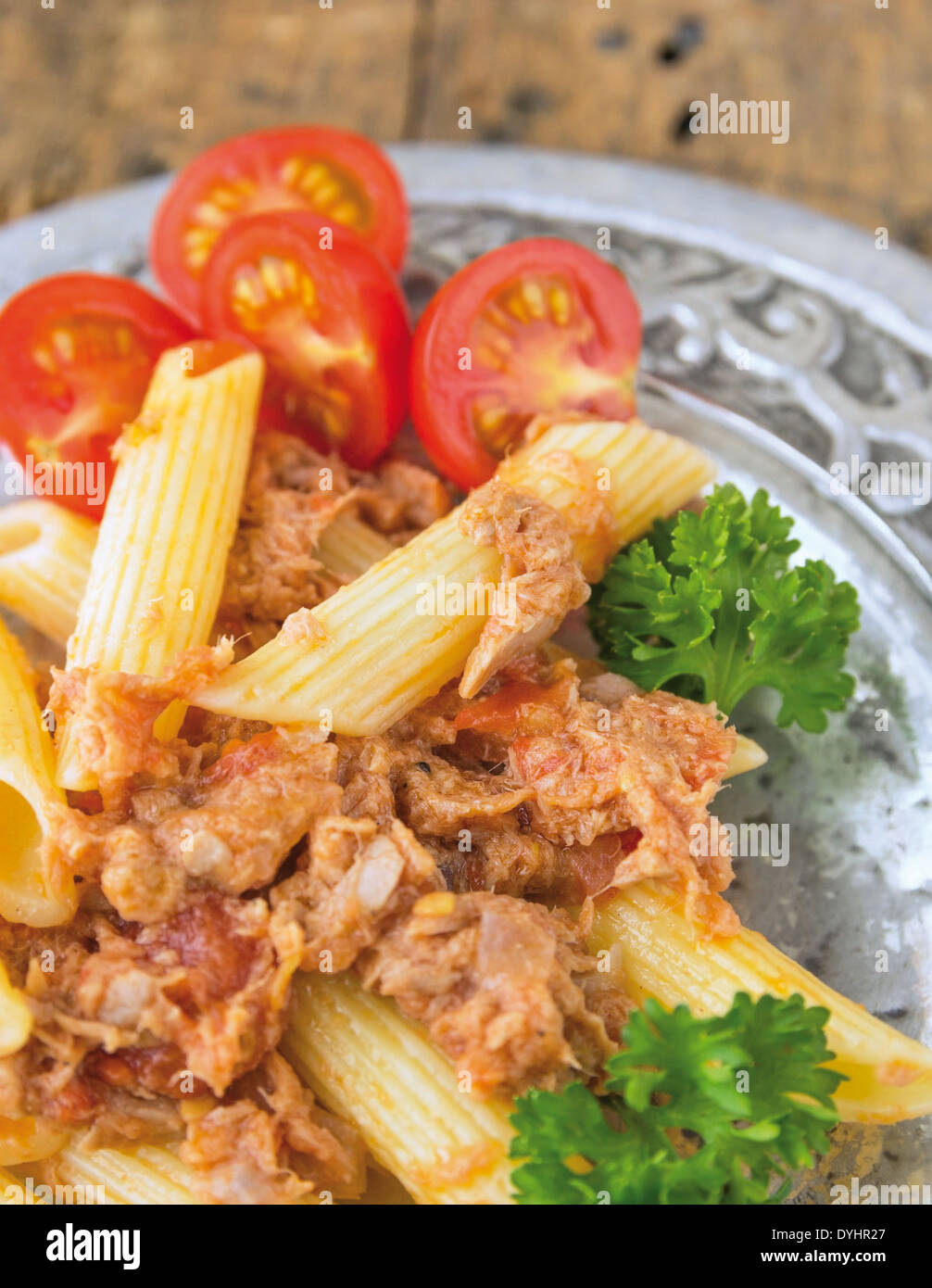 Tuna pasta with tomatoes in silver plate Stock Photo Alamy