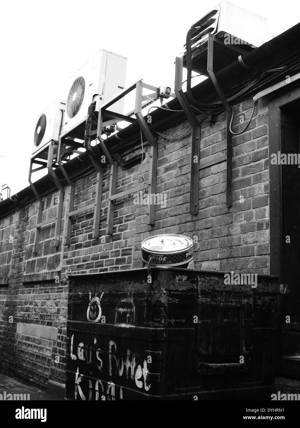 Monochrome image - Urban street scene showing ventilation / extractor fans and wheelie refuse bin, Newcastle upon Tyne, England Stock Photo