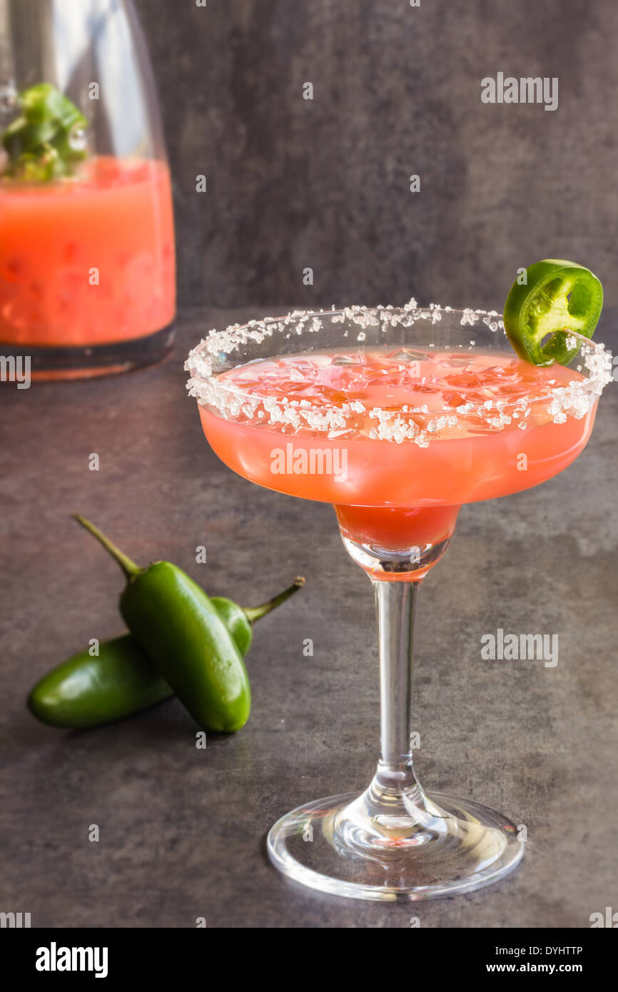 Spicy Hawaiian margarita made by soaking sliced jalapenos in guava