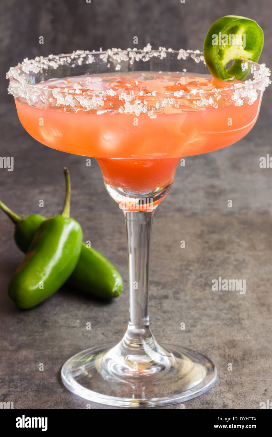 Spicy Hawaiian margarita made by soaking sliced jalapenos in guava