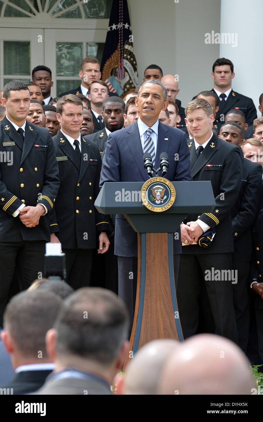 US President Barack Obama congratulates the US Naval Academy football team during an event on the South Lawn of the White House April 18, 2014 in Washington, D.C. The president presented the Navy Midshipmen with the Commander-in-Chief's Trophy, which goes to the Department of Defense academy team with the most victories against its Service rivals. Stock Photo