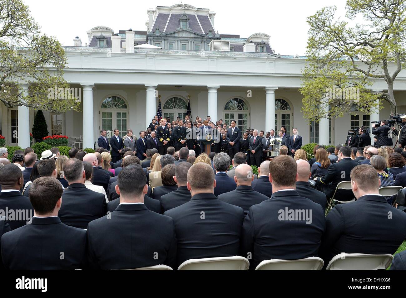 US President Barack Obama congratulates the US Naval Academy football team during an event on the South Lawn of the White House April 18, 2014 in Washington, D.C. The president presented the Navy Midshipmen with the Commander-in-Chief's Trophy, which goes to the Department of Defense academy team with the most victories against its Service rivals. Stock Photo