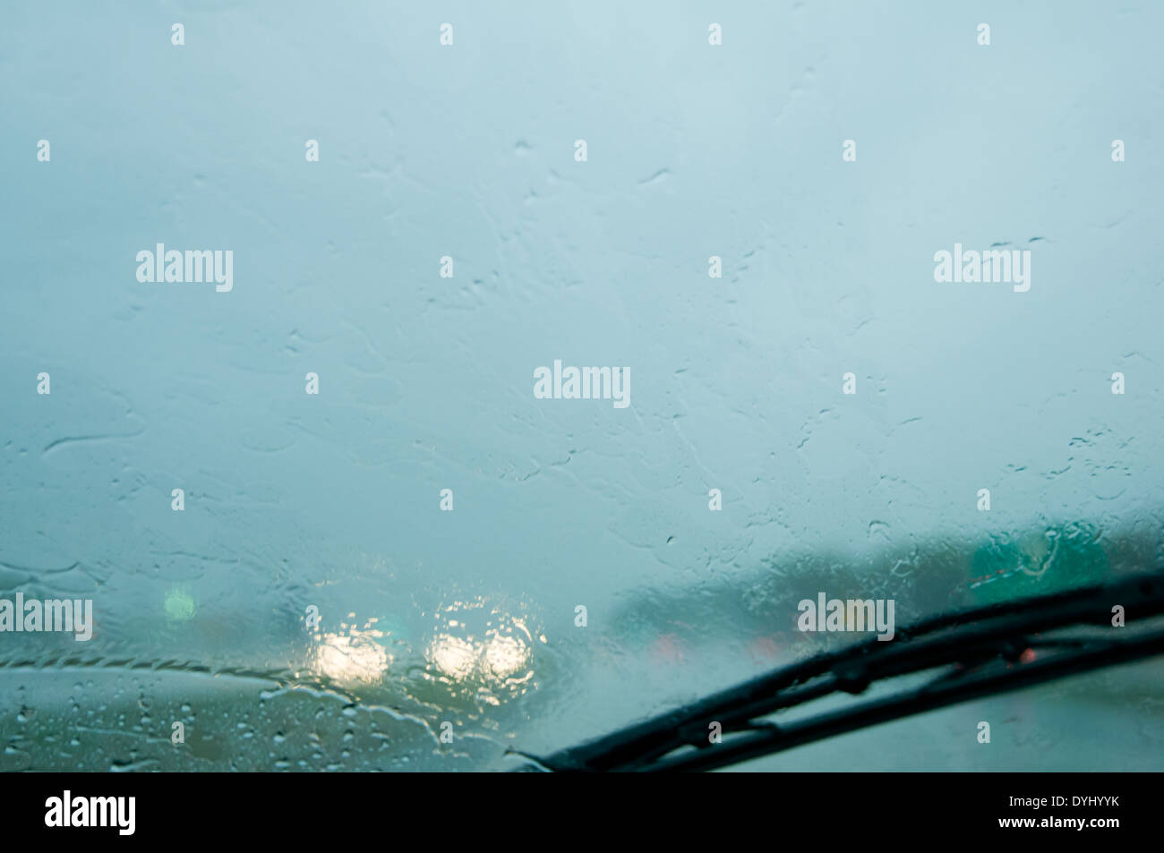 Rain covered windshield with wipers while driving on the interstate. USA. Stock Photo
