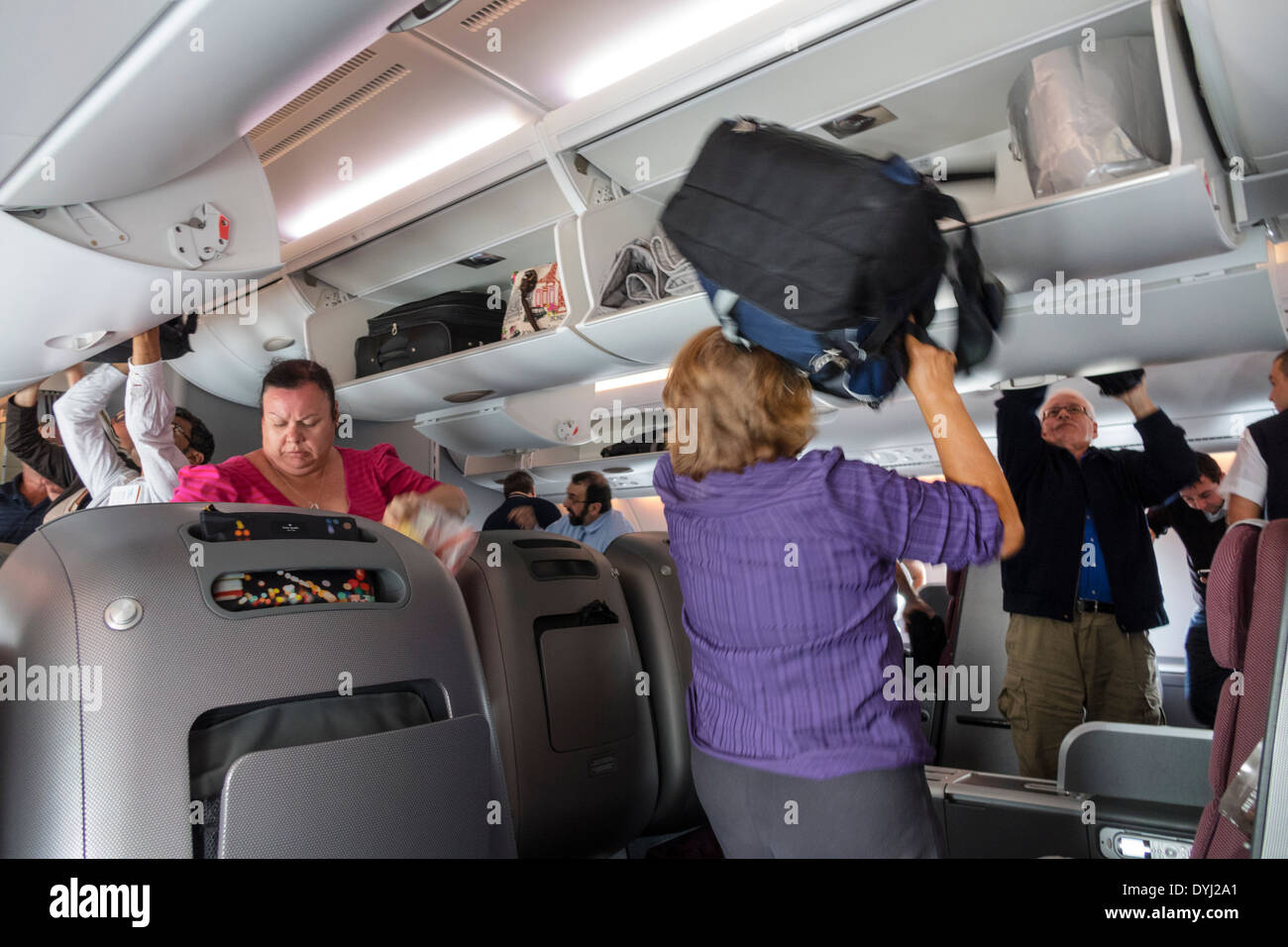 Melbourne Australia,Tullamarine Airport,MEL,Qantas,airlines,onboard,flight,passenger cabin,class,passenger passengers rider riders,disembarking,carry Stock Photo