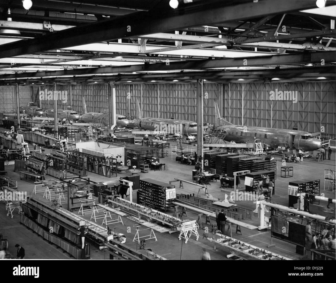 This image shows the assembly line for the Convair 240, a twin-engine, propeller-driven airliner developed in the late 1940s. The Convair 240 was used for commercial and military transport, marking a significant advancement in civilian aviation technology at the time. Stock Photo