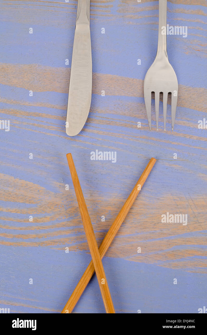 Chopsticks vs knife and fork, a concept Stock Photo Alamy