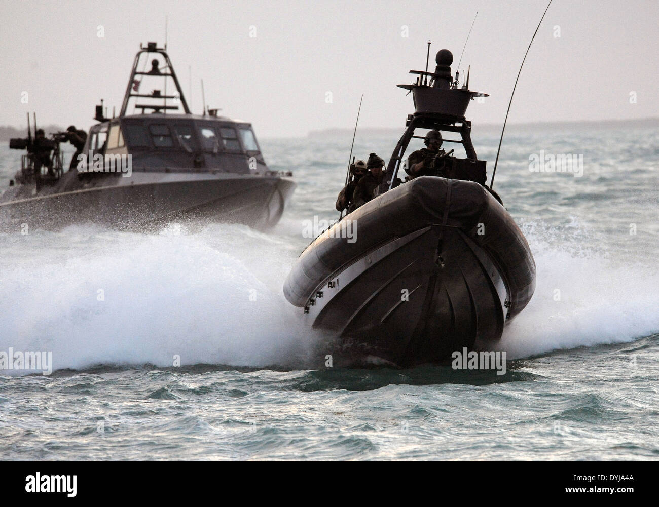 US Navy SEAL Special Warfare Combatant craft Crewmen assigned to Special Boat Team 20 navigates a rigid-hull inflatable boat film a scene in a movie production ¨I Am That Man” July 9, 2008 in Key West, Florida. Stock Photo