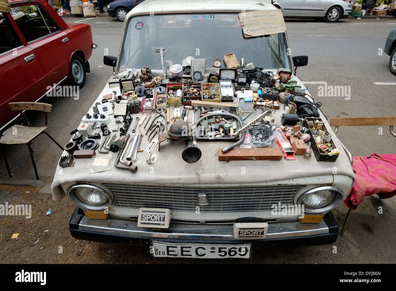 A vendor's items are displayed on the hood of a car at the 'Dry Bridge Bazaar' market  for used objects in Tbilisi capital of the Republic of Georgia Stock Photo
