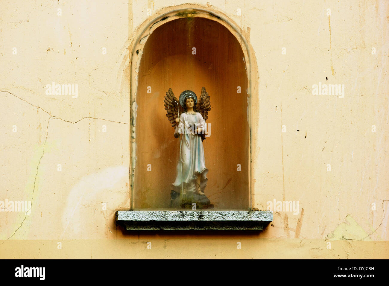 Shrine with angel figure holding a fish in traditional district of Alfama Lisbon Portugal western Europe. Stock Photo