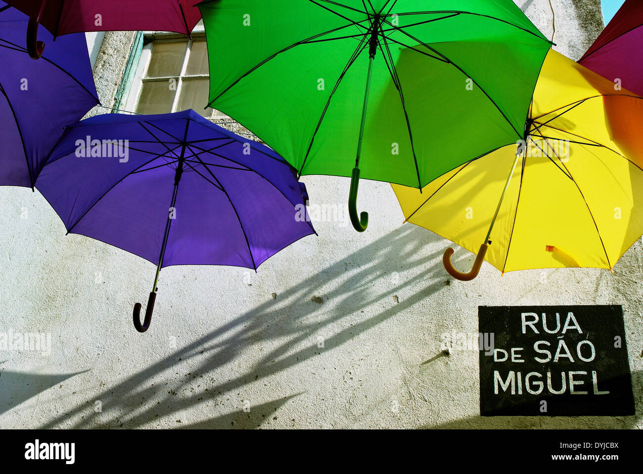 Colorful umbrellas hanging suspended above a street in the district of