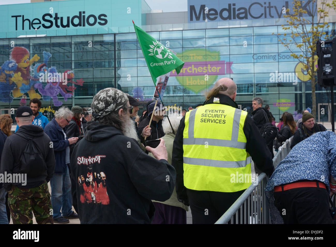 MANCHESTER, UK Saturday 19th. April 2014. Security guard standing among a small group of anti-BBC protesters outside the BBC Studios at Media City in Salford Quays. Credit:  Dave Ellison/Alamy Live News Stock Photo