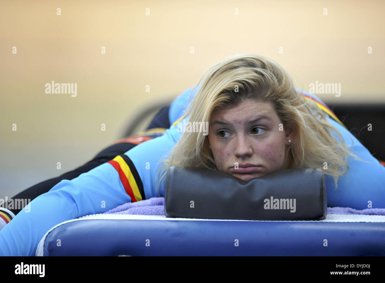 London, UK. 18th April 2014. A female Belgian cyclist stretching prior