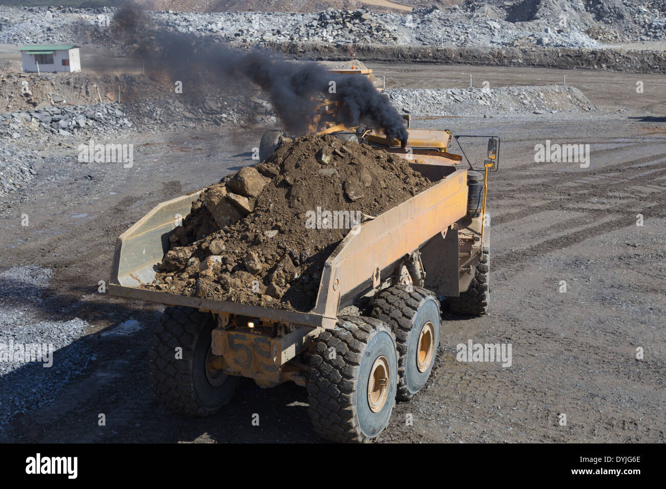 A volvo dump truck reverses in a large open cast copper mine. Stock Photo