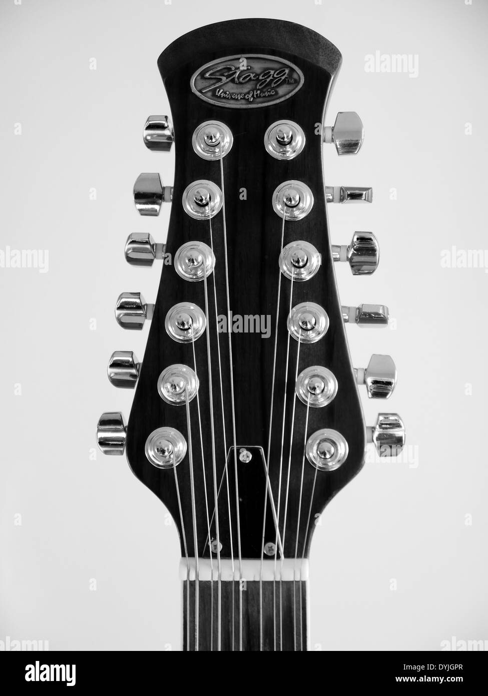 Head-stock of 12 string Stagg electro/acoustic guitar - front view - monochrome Stock Photo