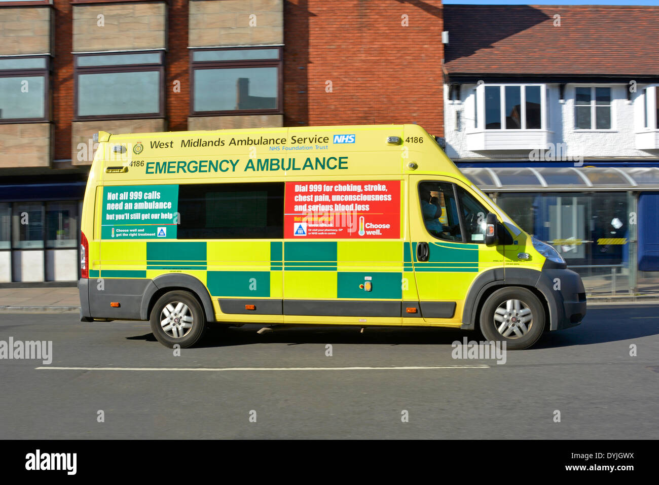 West Midlands NHS emergency ambulance with advertising panels explaining the correct use of 999 calls Stratford upon Avon Warwickshire England UK Stock Photo