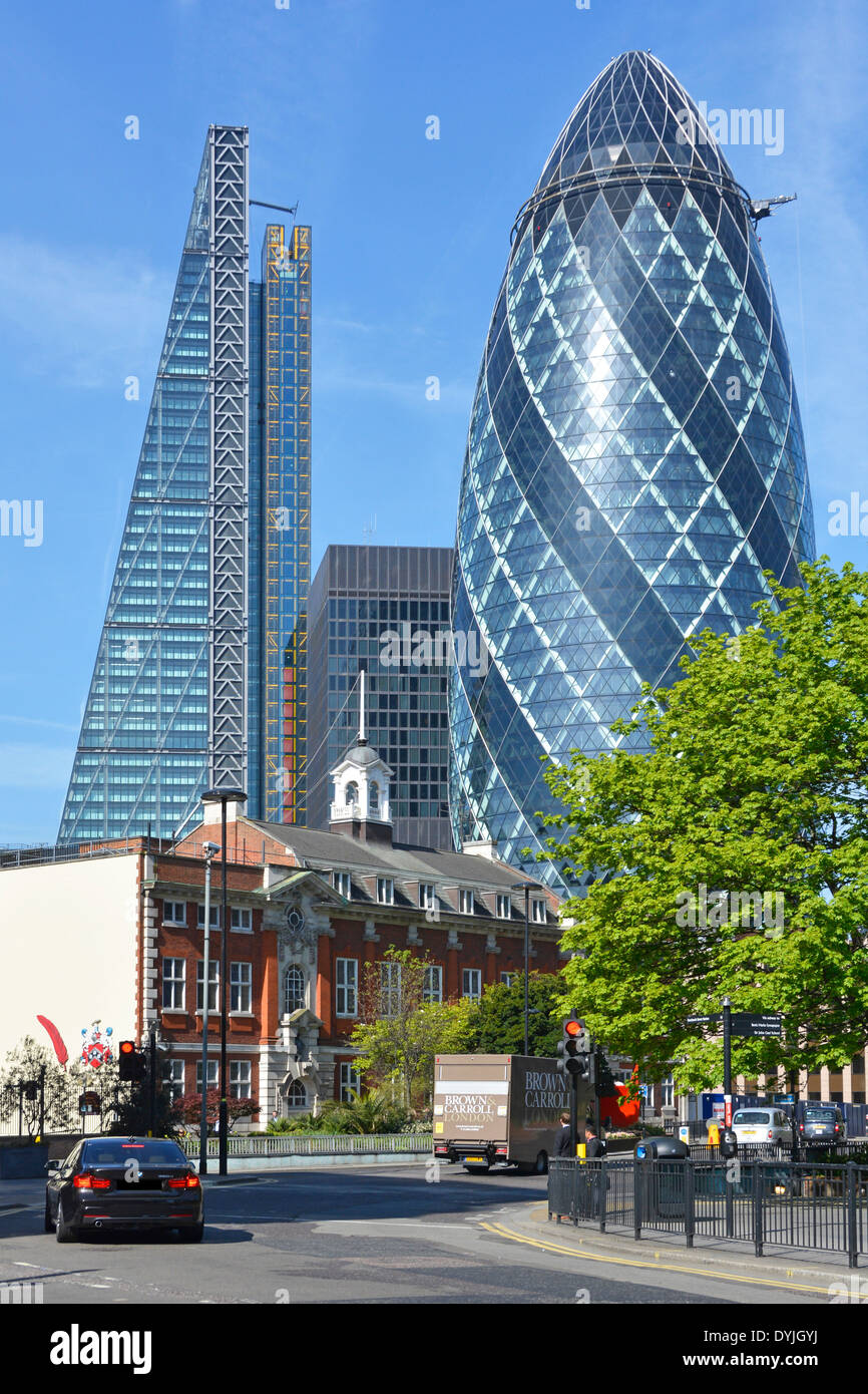 Gherkin office block landmark building & Leadenhall Cheese Grater skyscraper in City of London Sir John Cass school foreground Aldgate England UK Stock Photo