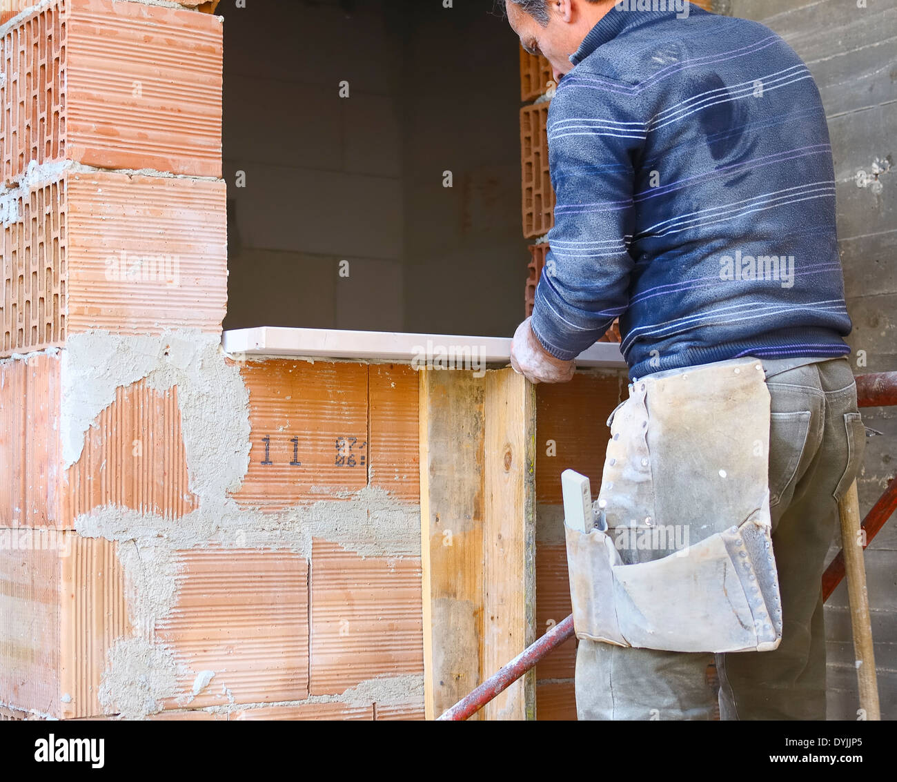 Worker wall cladding stone Stock Photo - Alamy