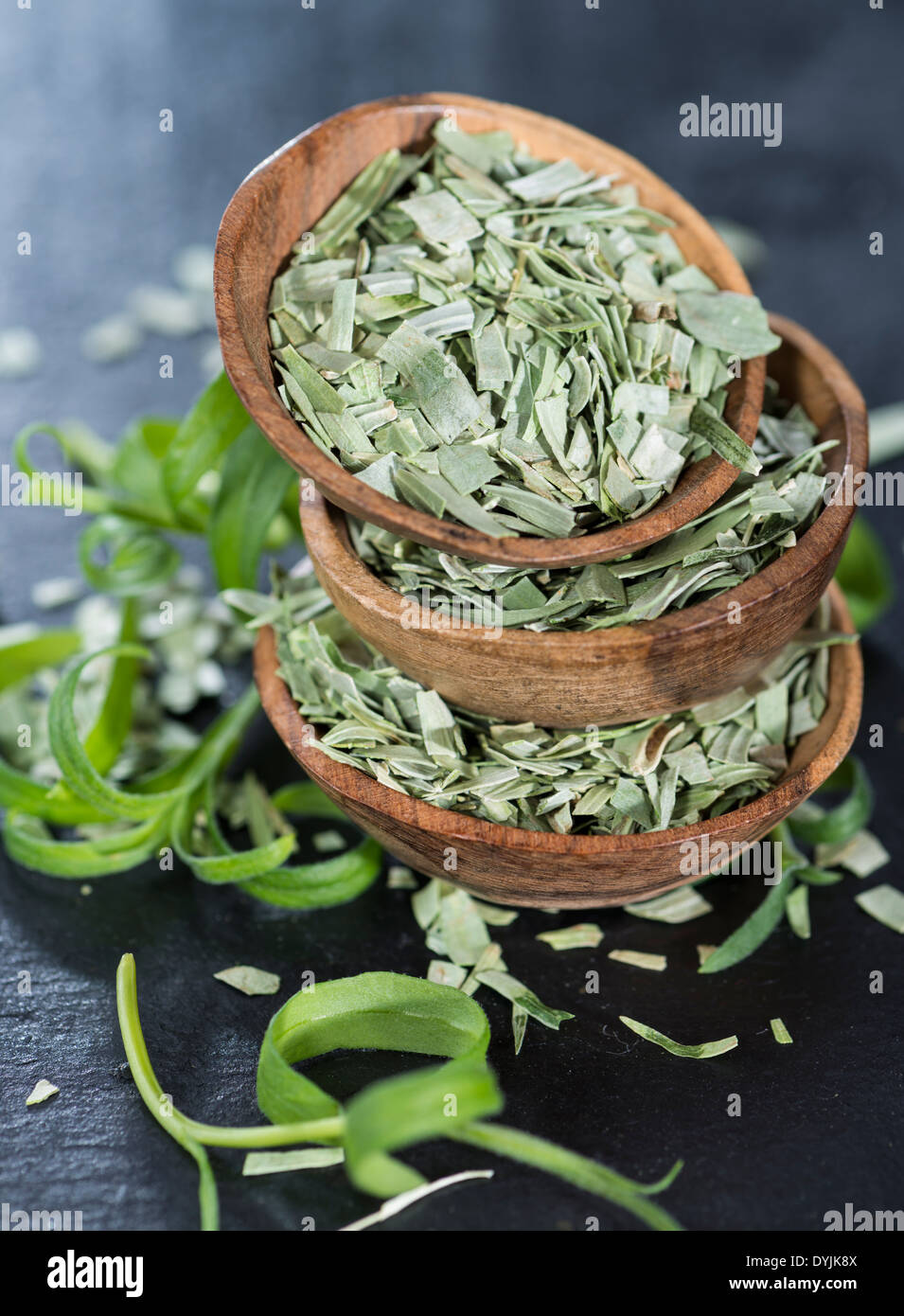Some small stacked bowls with dried Tarragon Stock Photo