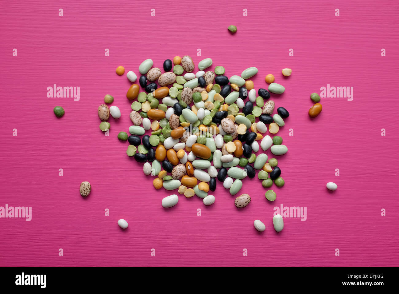 Mixed dried beans and peas on a pink background Stock Photo Alamy