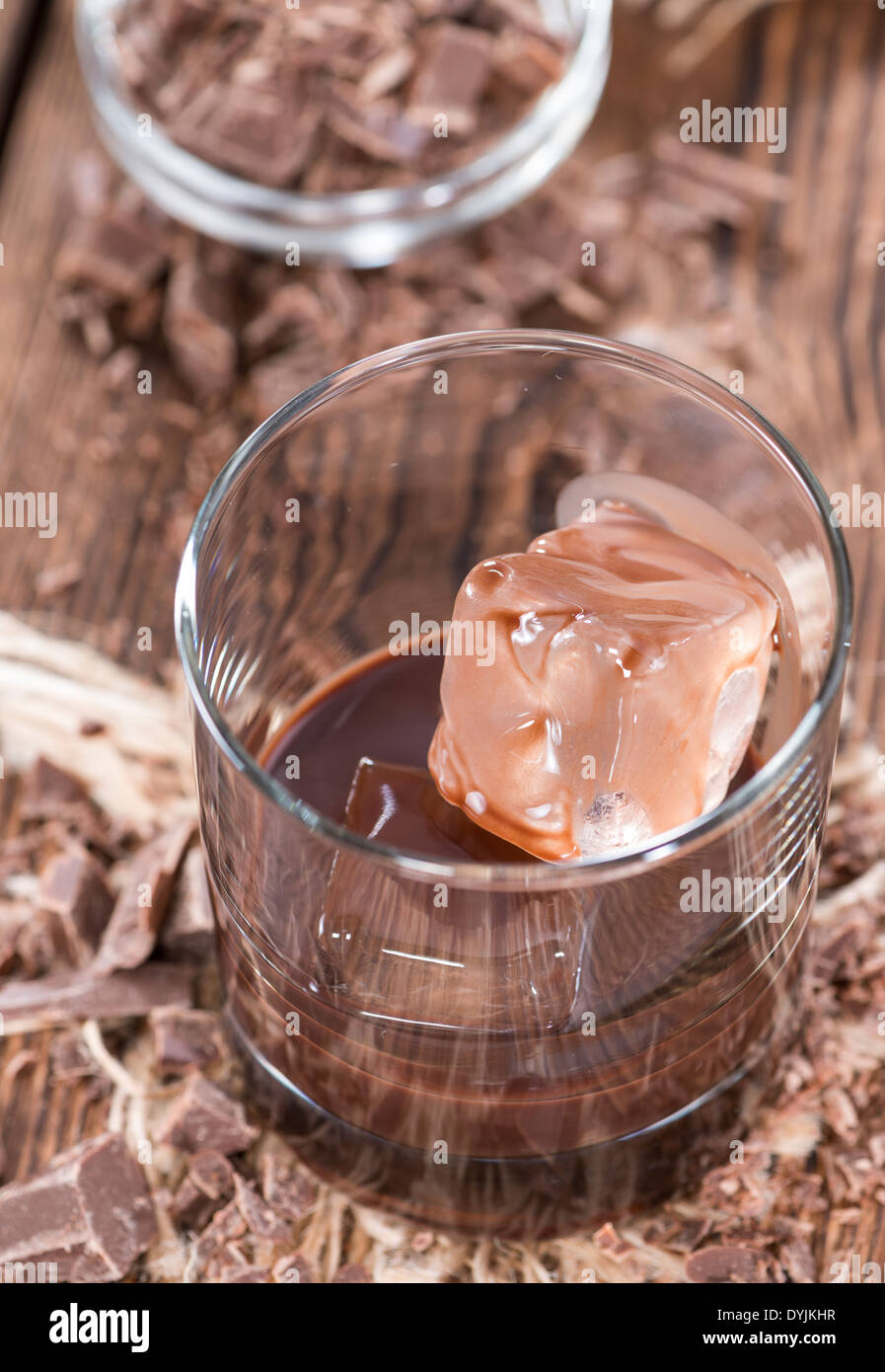 Homemade brown Chocolate Liqueur with some fresh pieces of chocolate