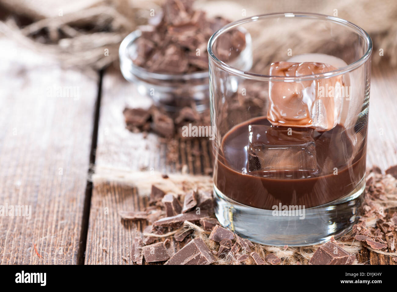 Homemade brown Chocolate Liqueur with some fresh pieces of chocolate