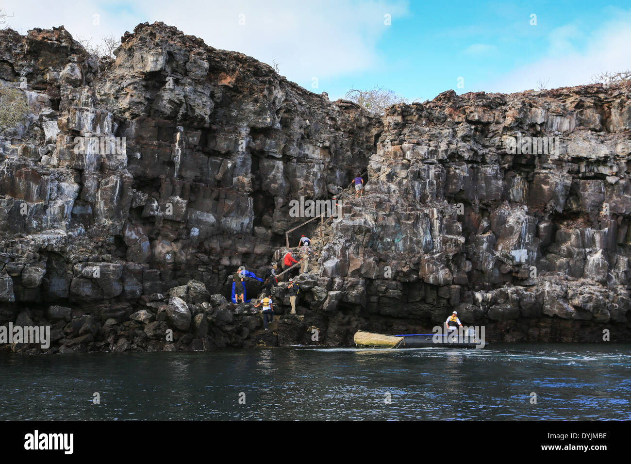 Tourists climbing the steep rock staircase at the boat landing on