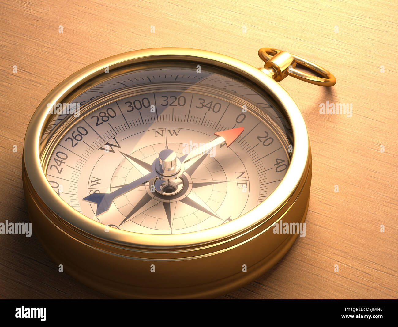 Compass on a wooden table with clipping path included. Stock Photo