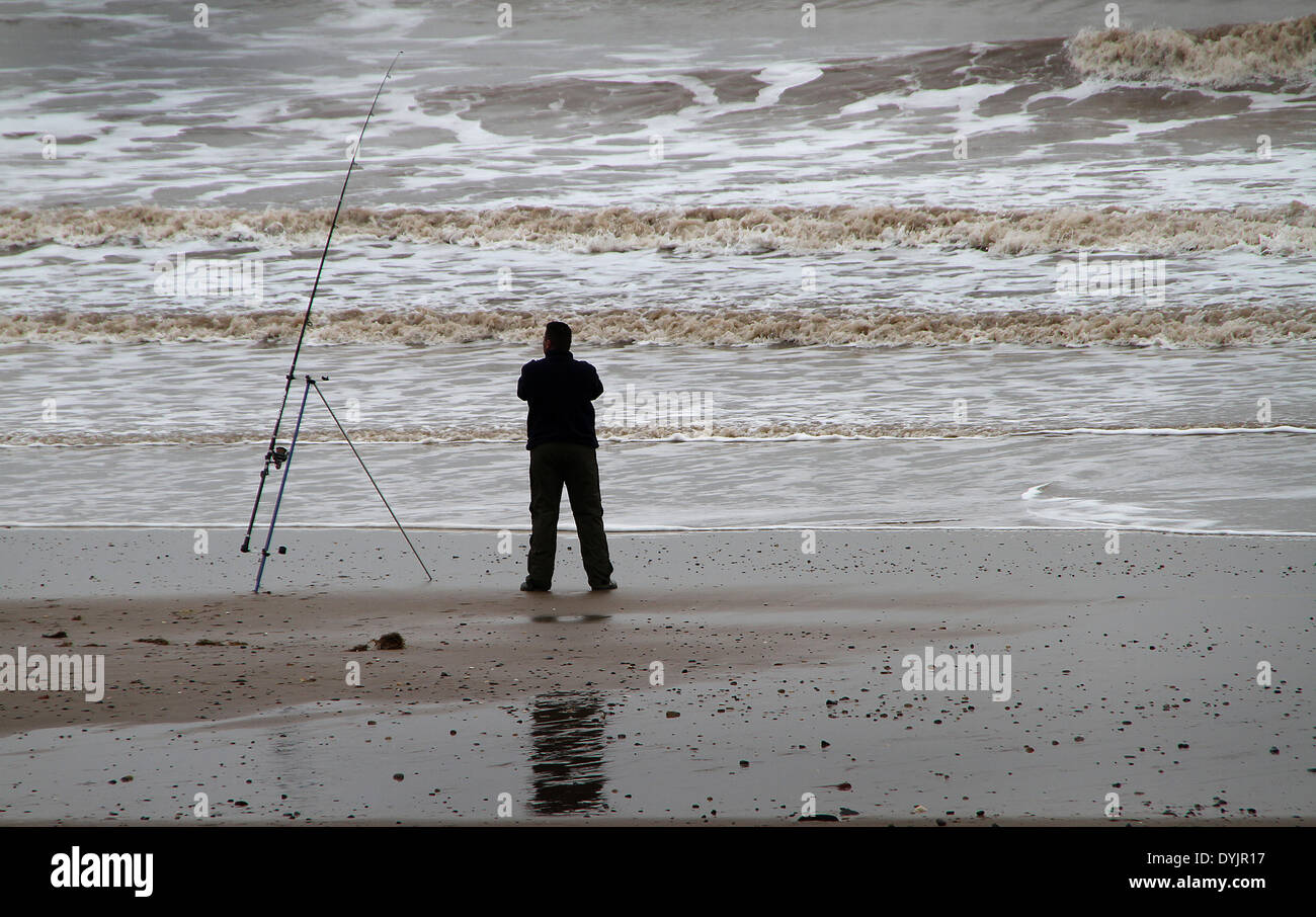 Beach angler in action. Stock Photo