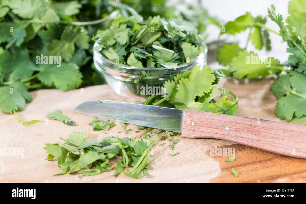 Portion of fresh green Cilantro leaves on wooden background Stock Photo