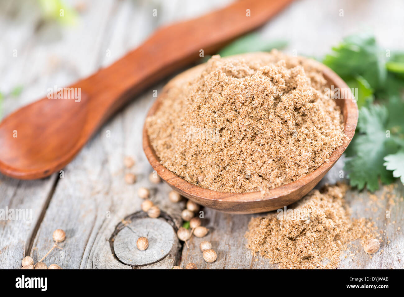 Small bowl with Cilantro Powder on weathered wood Stock Photo - Alamy