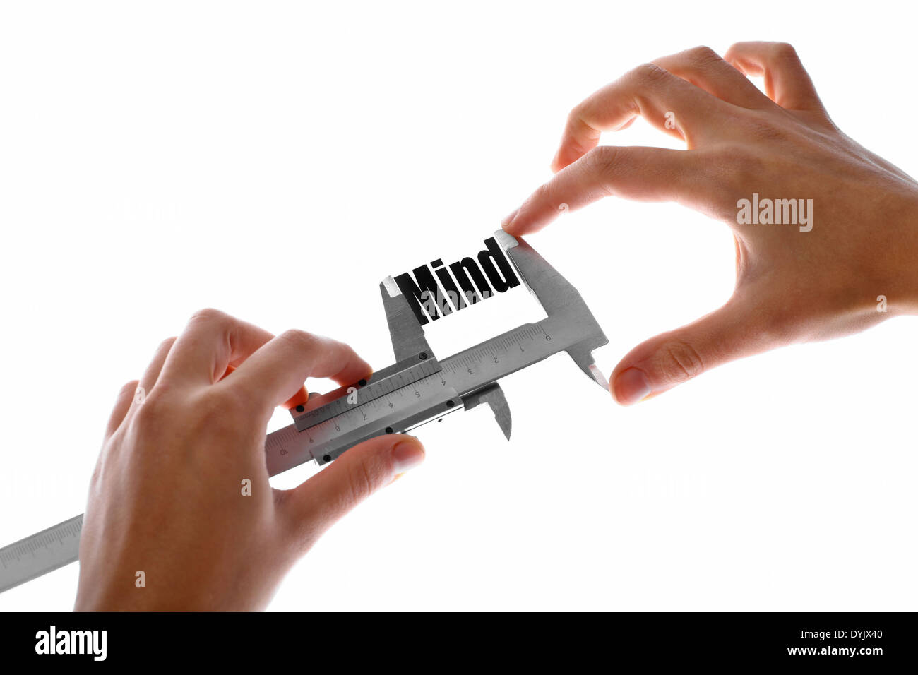 Two hands holding a caliper, measuring the word "Mind Stock Photo Alamy