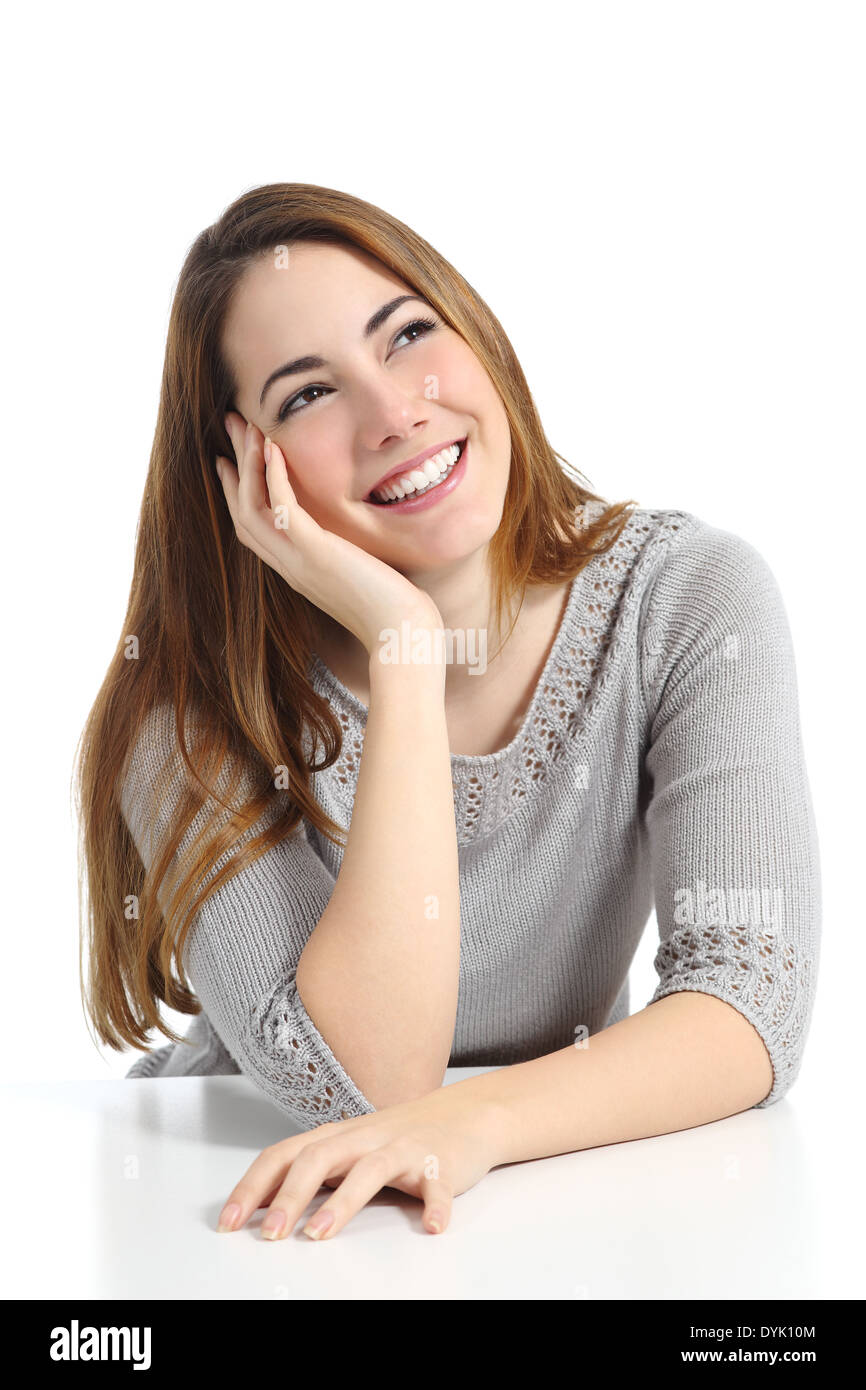 Beautiful dreamer woman thinking and dreaming looking sideways isolated on a white background Stock Photo