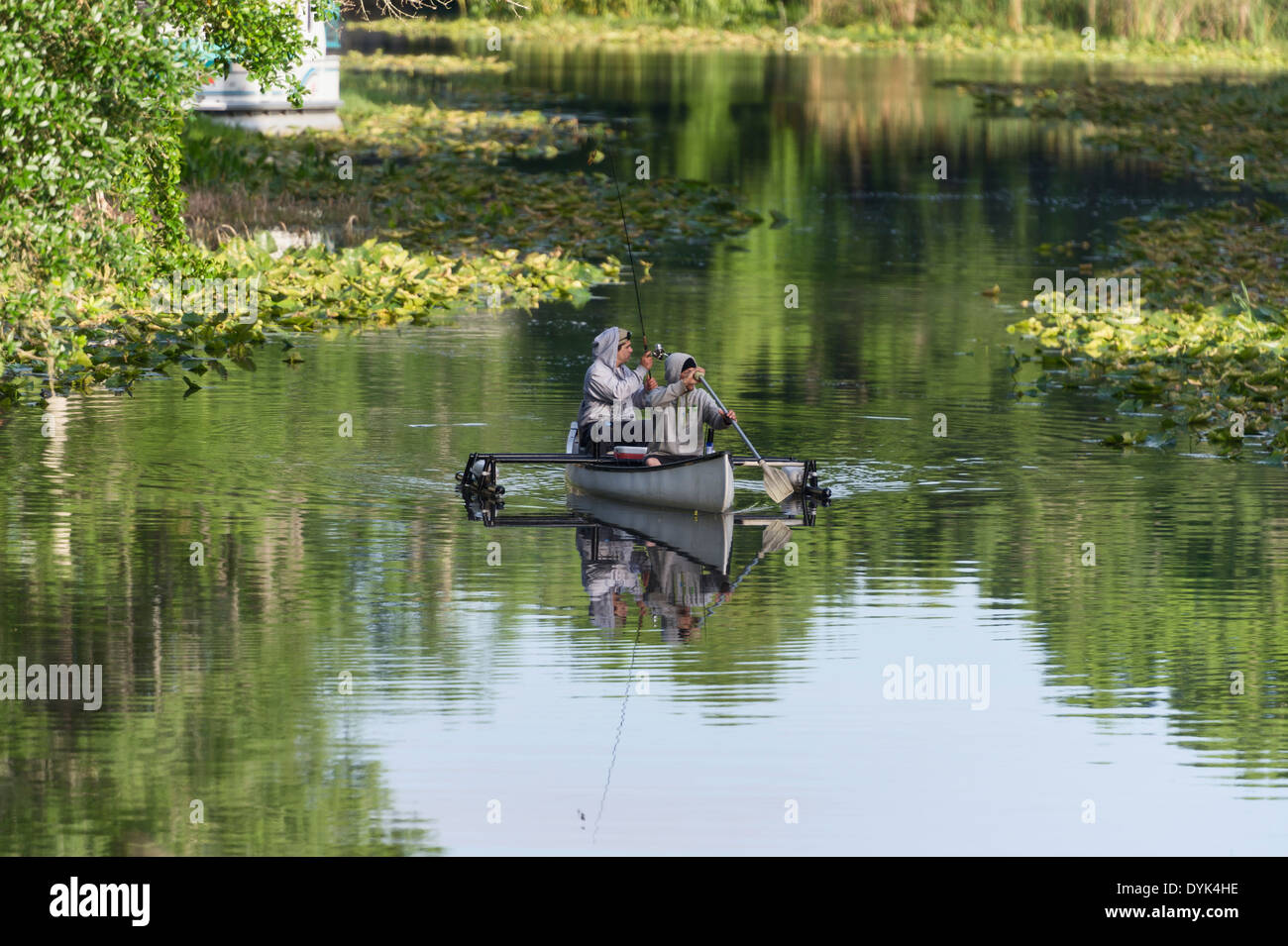 Two tourist fishing from a canoe on the Haines Creek River in Central