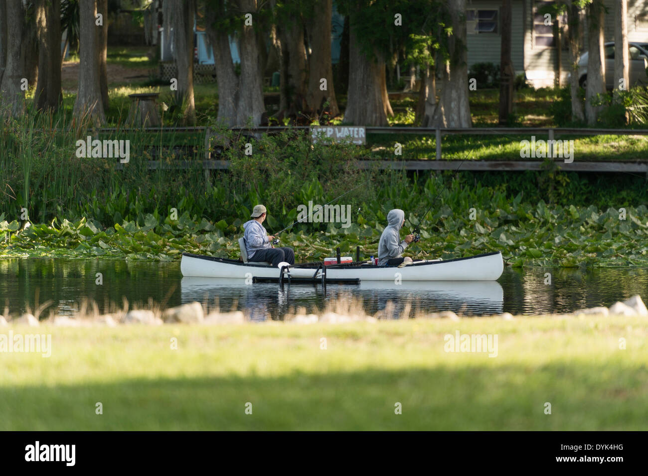 Two tourist fishing from a canoe on the Haines Creek River in Central