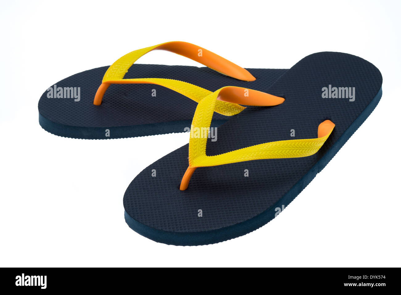 Black thong type flip-flops with orange and yellow straps - studio shot ...