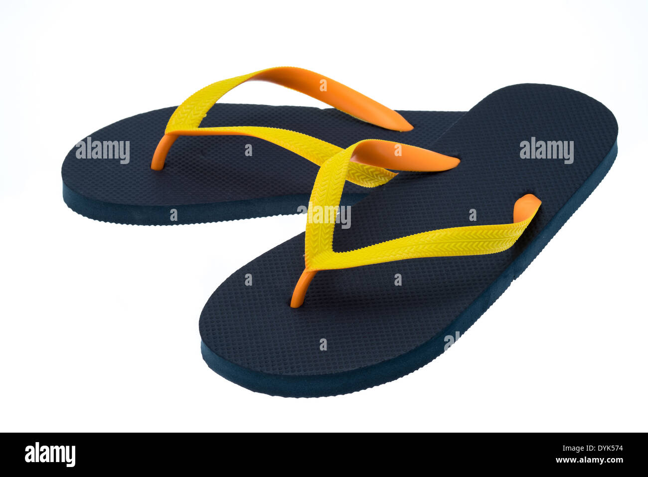 Black thong type flip-flops with orange and yellow straps - studio shot with a white background Stock Photo