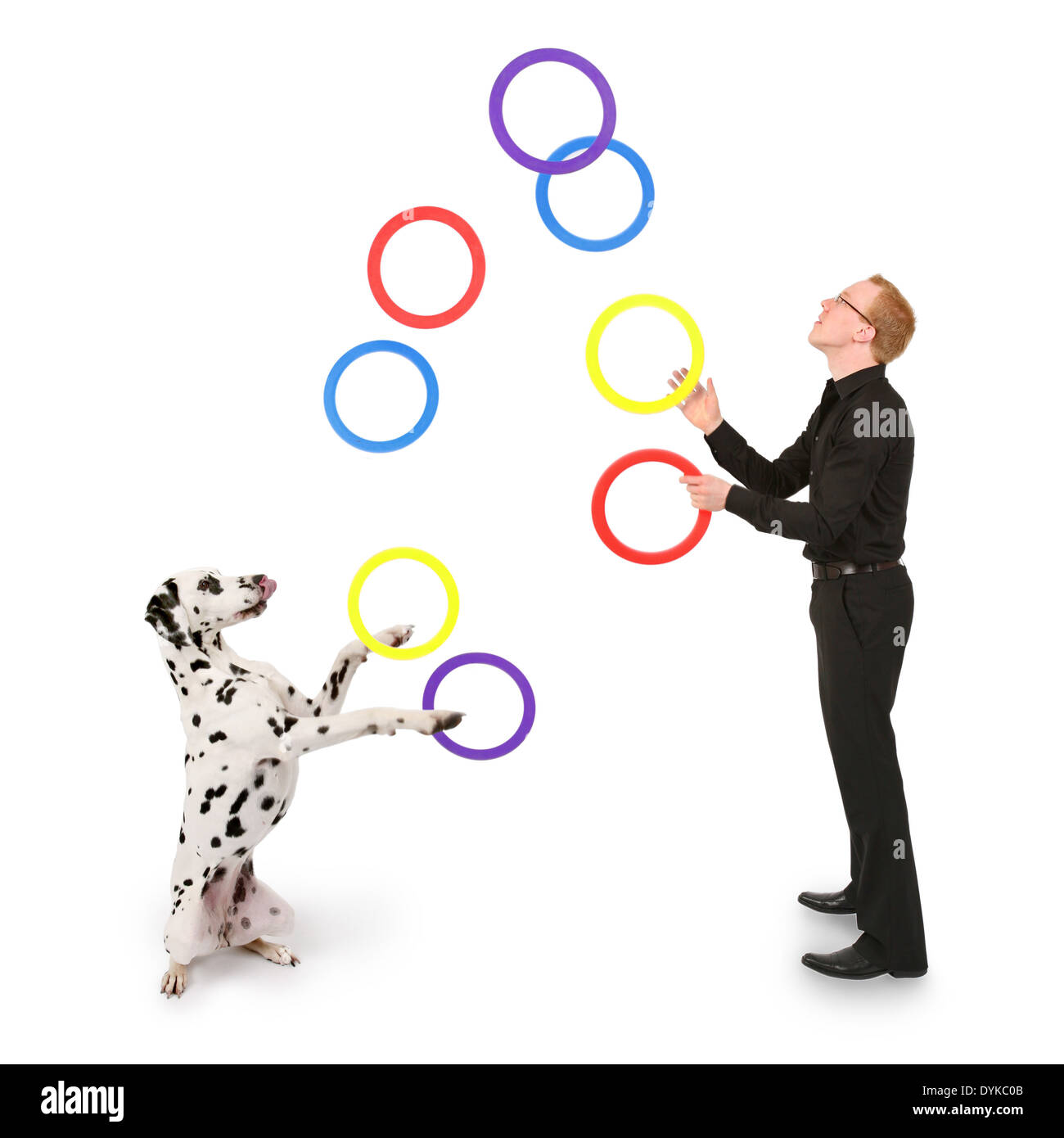 junger Mann jongliert mit Ringen, young man juggling with rings, Mann spielt mit Dalmatiner Stock Photo