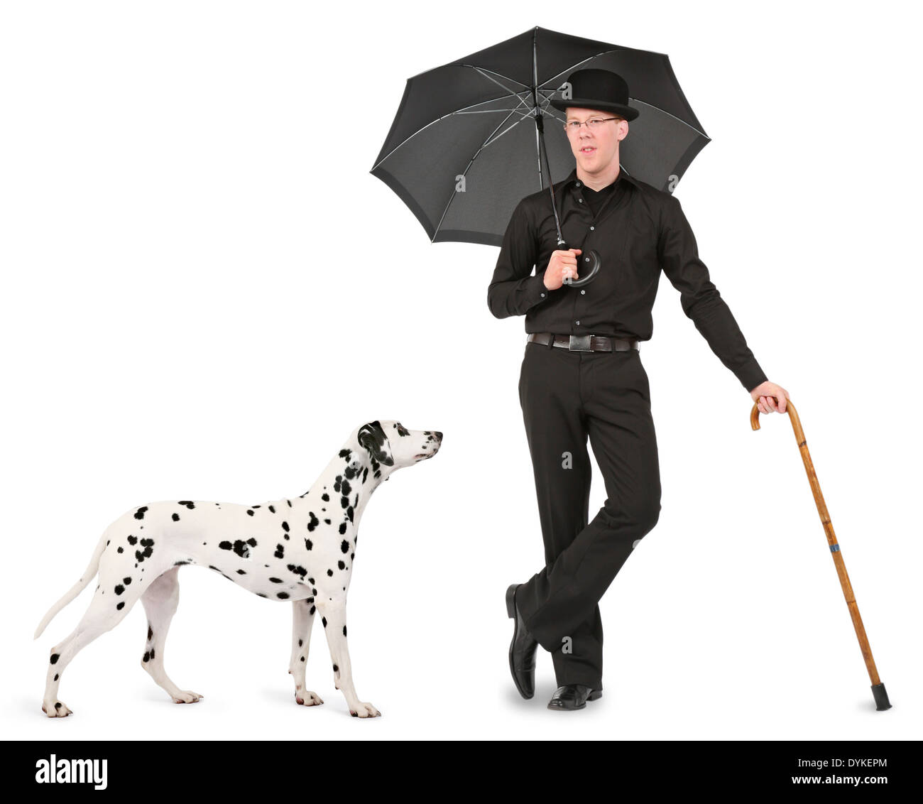young man with bowler hat, umbrella and walking stick dalmatiner dog Stock Photo