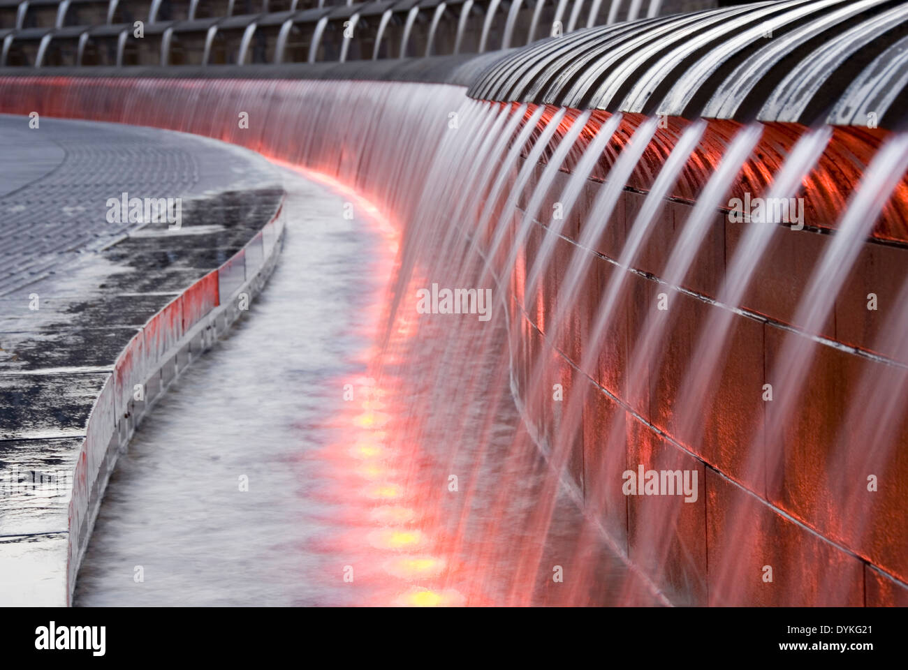 Sheaf Square, Sheffield, UK 02 Mar 2013: water pouring from Cascades water feature fountain lit up with red lights at night Stock Photo