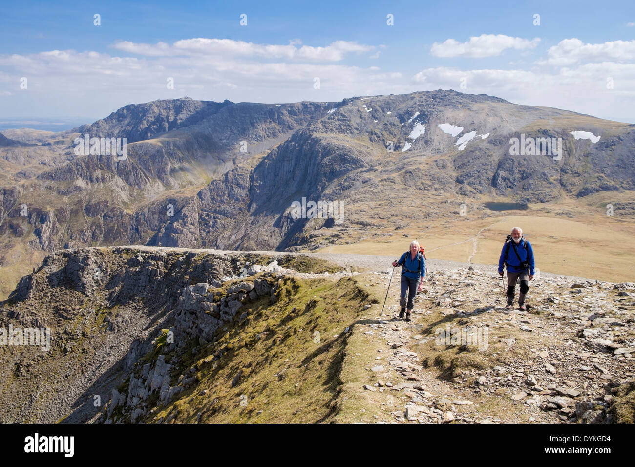 Two walkers climbing up Y Garn with view to the Glyderau in mountains of Snowdonia National Park (Eryri) Ogwen North Wales UK Britain Stock Photo