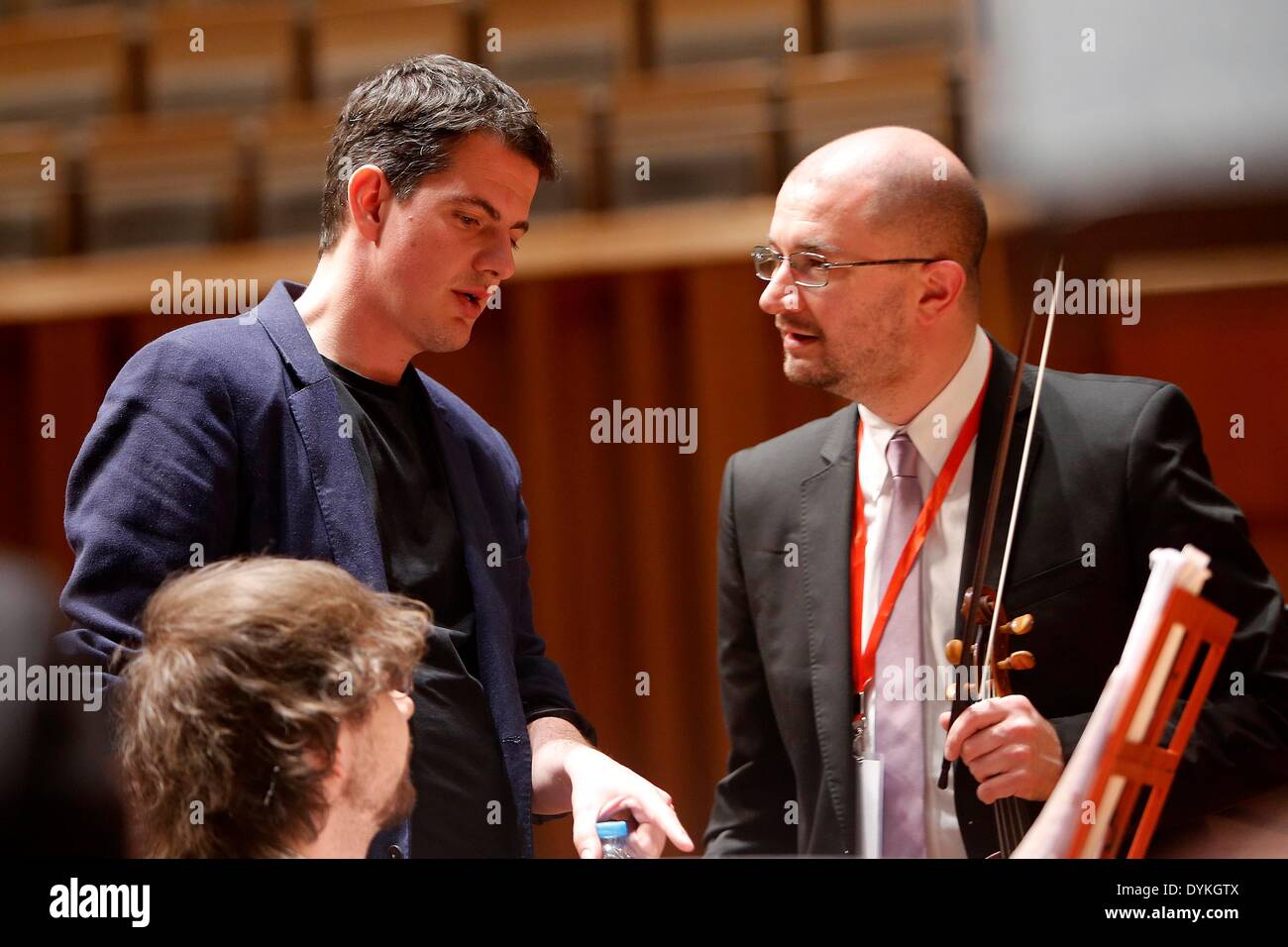 Beijing, China. 21st Apr, 2014. Philippe Jaroussky (L), French countertenor singer, talks with band members at the National Grand Theater in Beijing, capital of China, April 21, 2014. The 'Philippe Jaroussky and Venice Baroque Orchestra Concert' held on Monday was Philippe's debut in China. A countertenor is a type of classical male singing voice whose vocal range is equivalent to that of the female soprano, mezzo-soprano voice types. © Zhang Yuwei/Xinhua/Alamy Live News Stock Photo