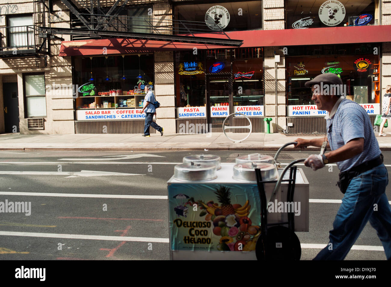 A man / food vendor pushing a push style food cart in Little Italy, New York City Stock Photo