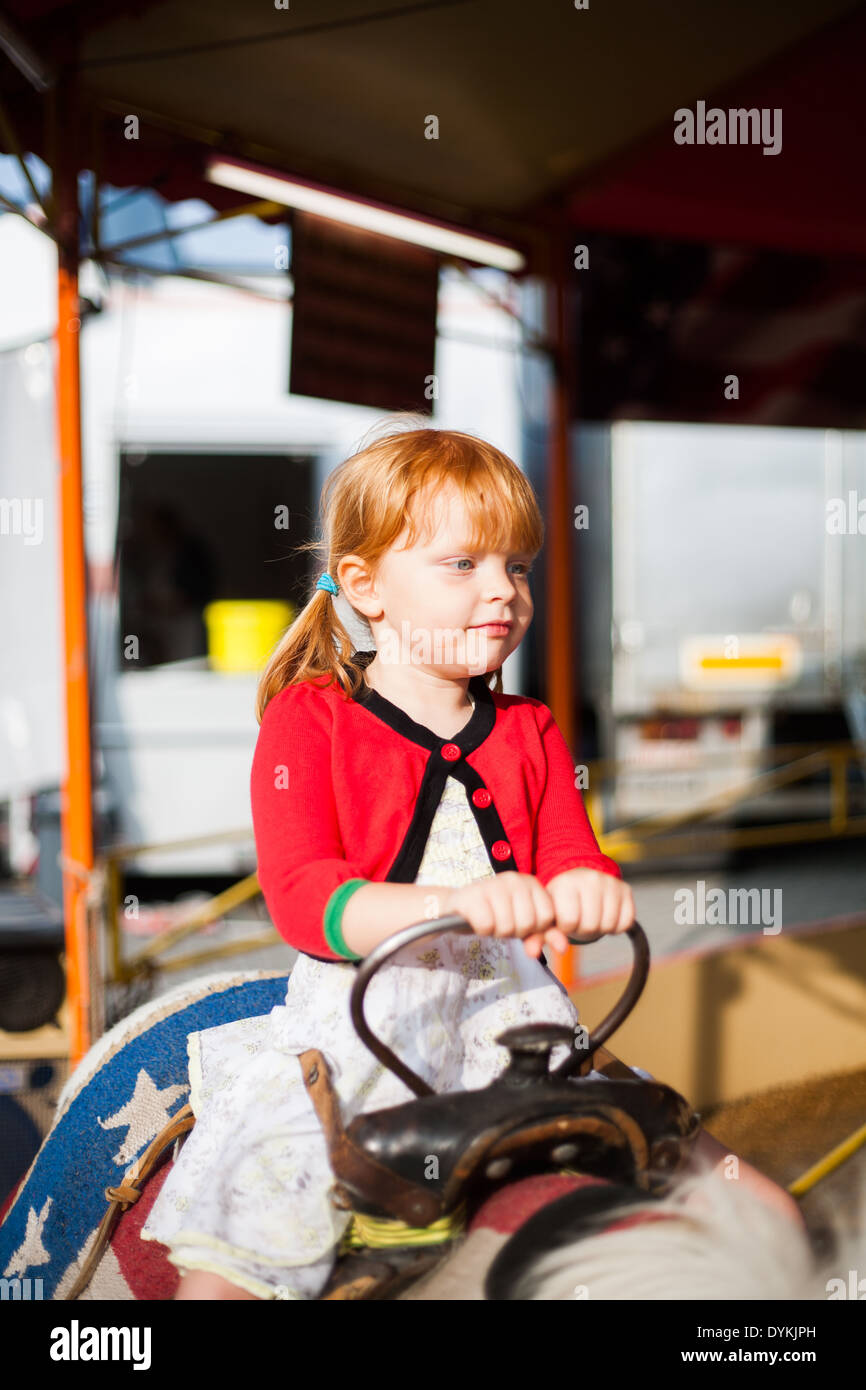 Child on colorful fair attraction having fun Stock Photo